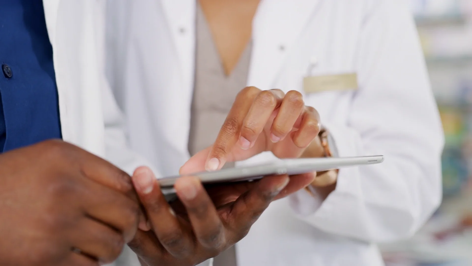Pharmacist managing barcoded medicine stock with HINAI Medics pharmacy software